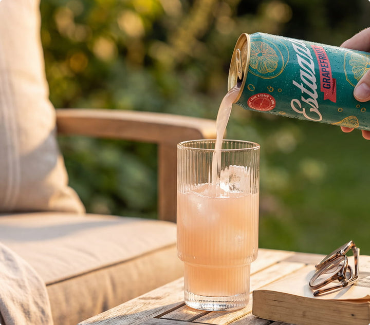 Couple relaxing on a porch with Estazzi drinks at sunset